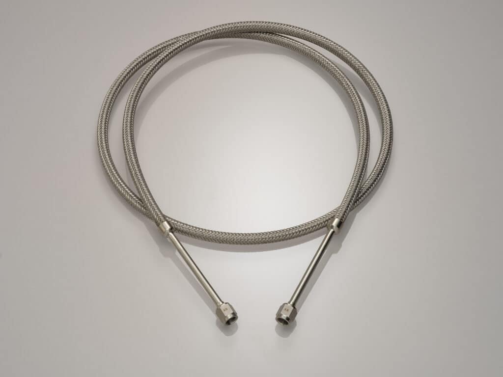 Stainless steel hose assemblies, like this one with VCR fittings, are used in semiconductor manufacturing equipment.